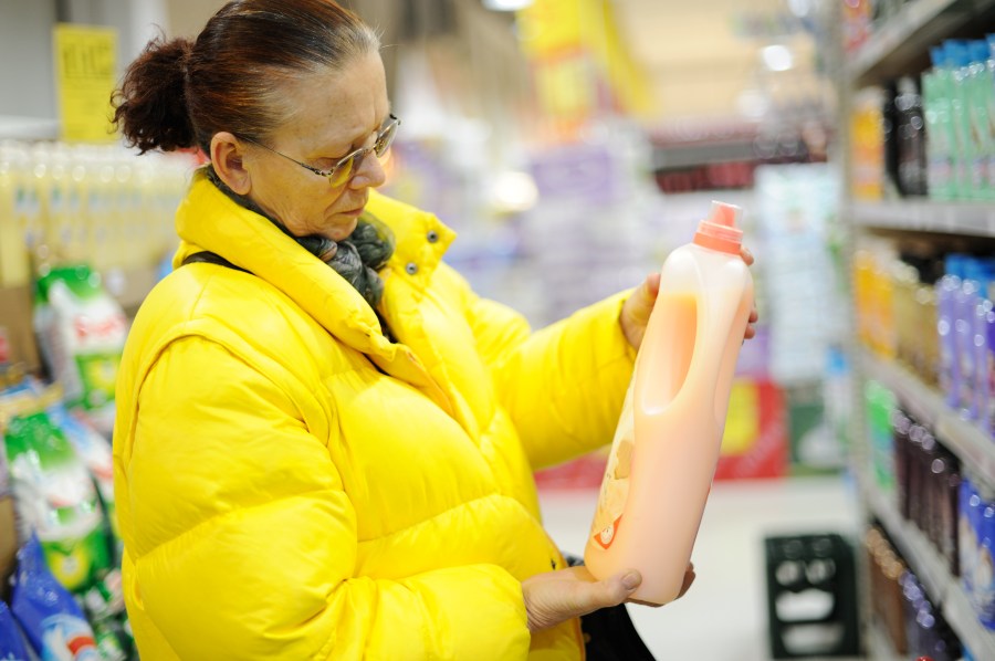 Elderly woman buying shampoo